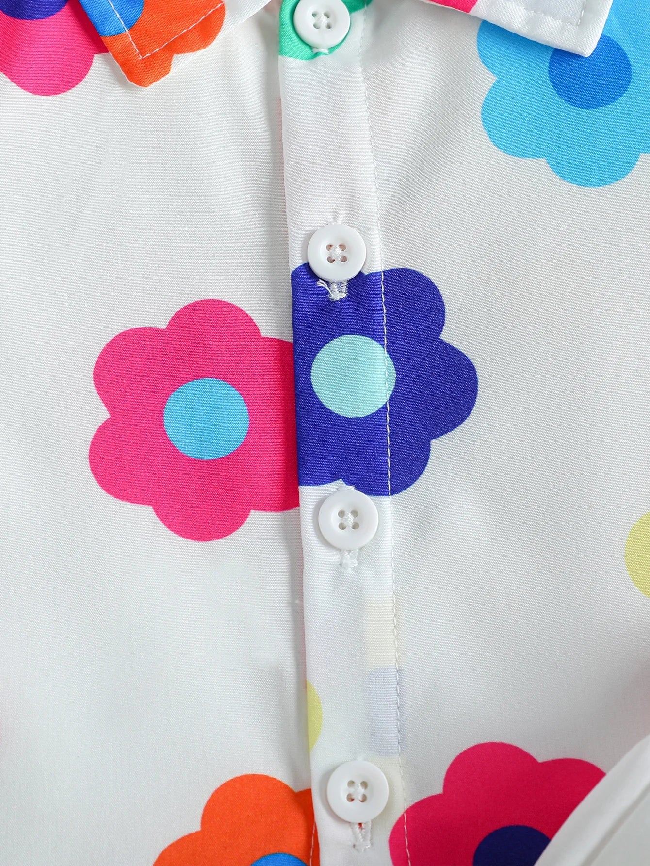 Detail shot of the soft fabric and floral pattern of the unisex baby summer romper and matching hat