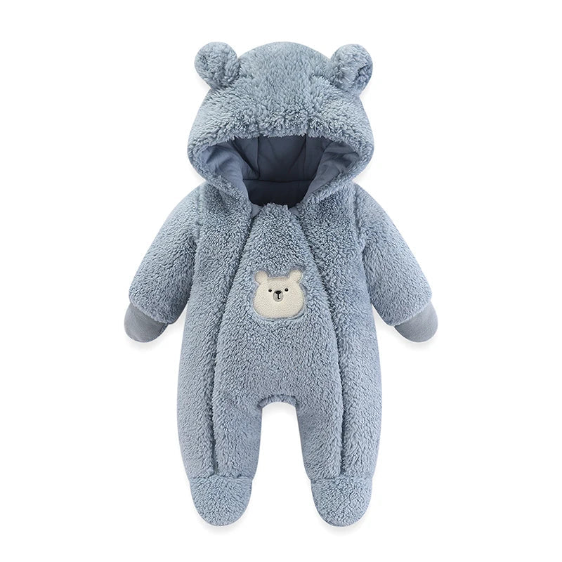 Front view of an infant wrapped in a soft, cartoon-themed hooded baby suit