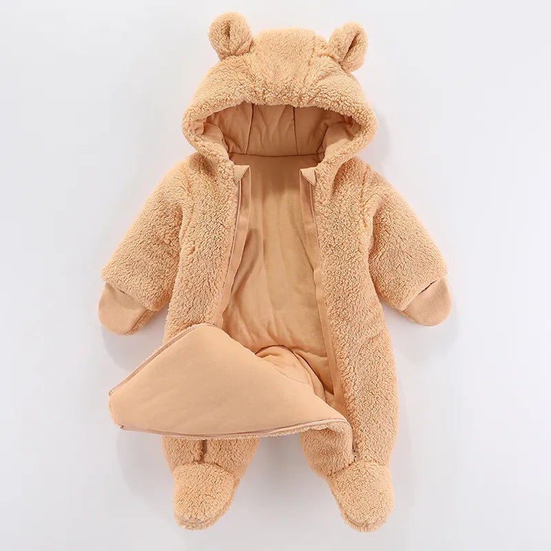 Newborn wearing a warm unisex cartoon-themed jumpsuit for winter comfort