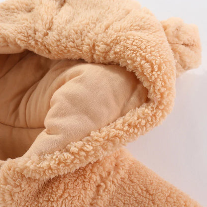 Close-up of fluffy hooded baby romper with adorable cartoon embroidery