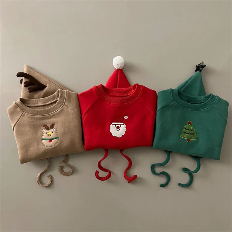 Side profile of a baby in a soft red cotton Santa romper and hat, comfortable toddler sweater.