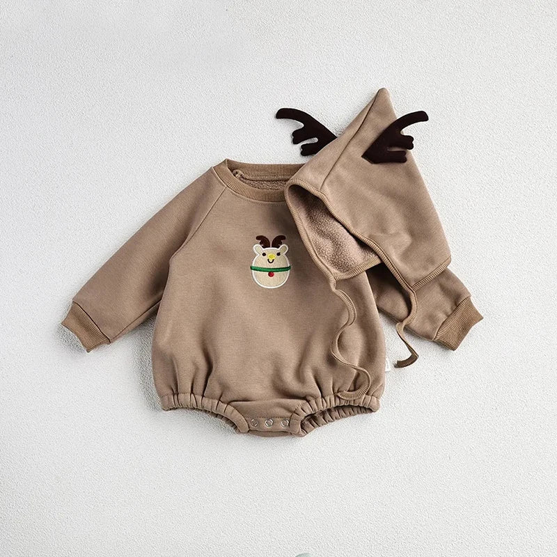 Baby crawling in a red Santa romper and hat on a festive background, holiday newborn clothes.
