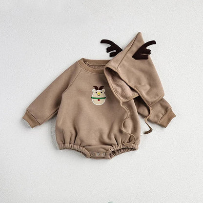 Baby crawling in a red Santa romper and hat on a festive background, holiday newborn clothes.