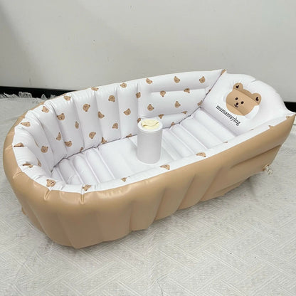 Infant bathing in a fun, brightly colored inflatable giraffe animal bathtub with support