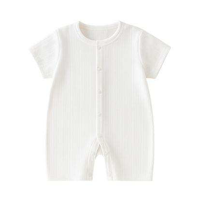Smiling baby wearing a soft cotton knit romper, unisex design, breathable and cozy infant jumpsuit.