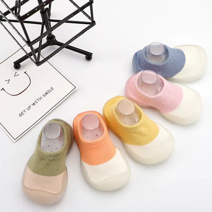 Baby's feet in cozy knit boots, soft sole supporting development
