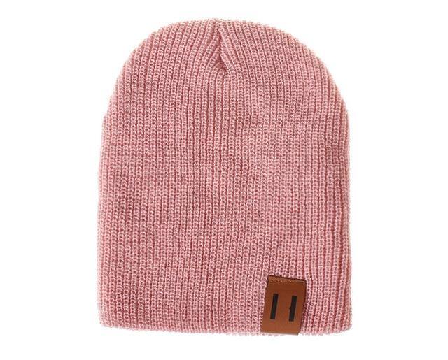 Child wearing a warm knitted beanie hat, unisex crochet cap for winter fun