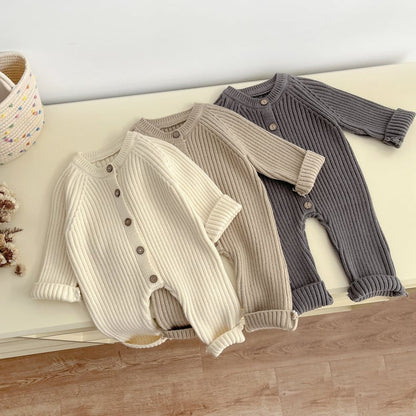 Close-up of soft knitted texture on a unisex baby long-sleeve cotton romper