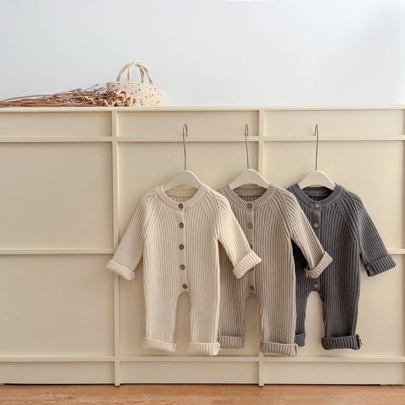 Full view of a unisex baby knitted romper in a neutral color, perfect for winter wear