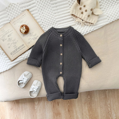 Knitted romper for baby, featuring long sleeves and a soft cotton blend for comfort