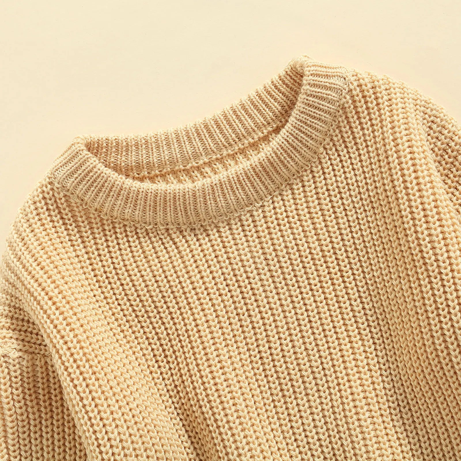 Unisex baby knitted sweater in a soft beige color, comfortable winter pullover for kids