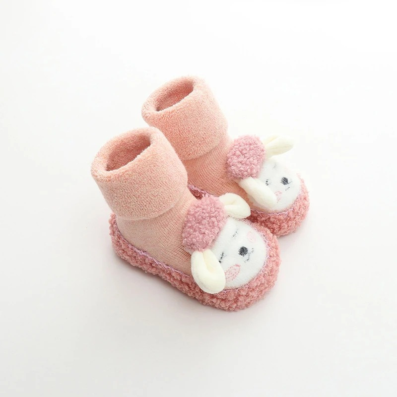 Infant booties with grip: unisex baby plush anti-slip cartoon shoes, ideal for tiny feet.