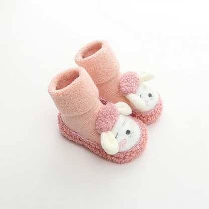 Infant booties with grip: unisex baby plush anti-slip cartoon shoes, ideal for tiny feet.