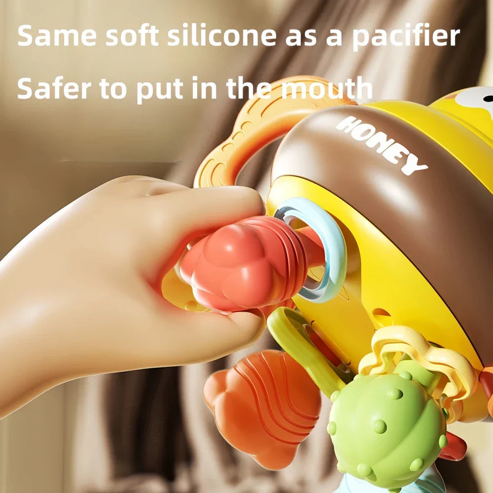 Colorful unisex infant development toy, combining a soft rattle and textured teether for young children.