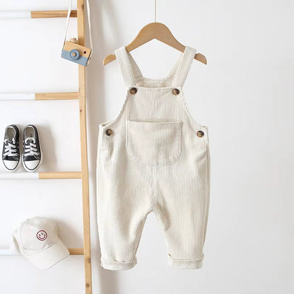 Happy baby crawling in comfortable unisex ribbed fabric overalls, durable toddler fashion.