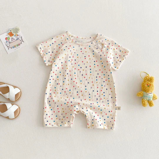 Folded unisex baby romper made from breathable fabric, showcasing its fun dolphin print and convenience.