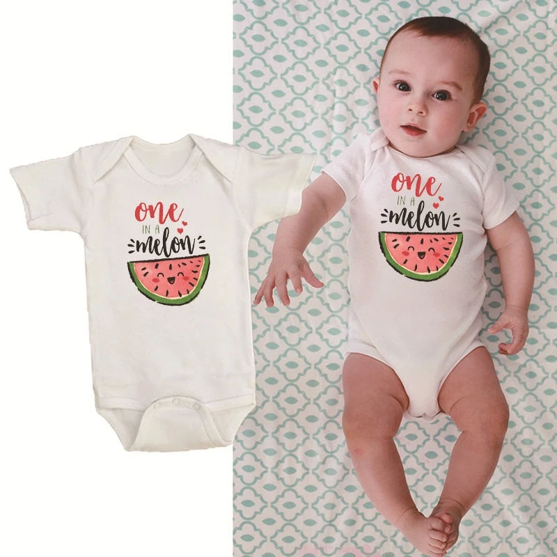 Close-up of 'One in a Melon' text and watermelon graphic on a short sleeve baby romper