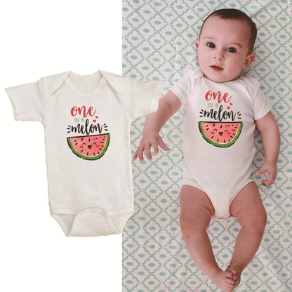 Close-up of 'One in a Melon' text and watermelon graphic on a short sleeve baby romper