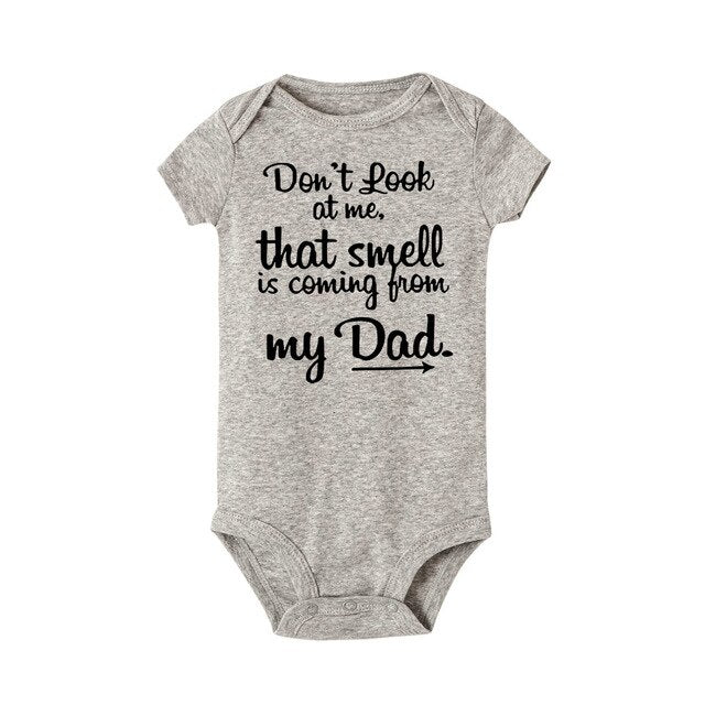 Infant wearing comfortable white unisex baby romper, perfect playful outfit