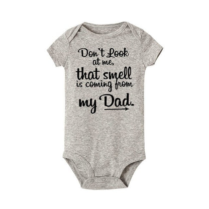 Infant wearing comfortable white unisex baby romper, perfect playful outfit