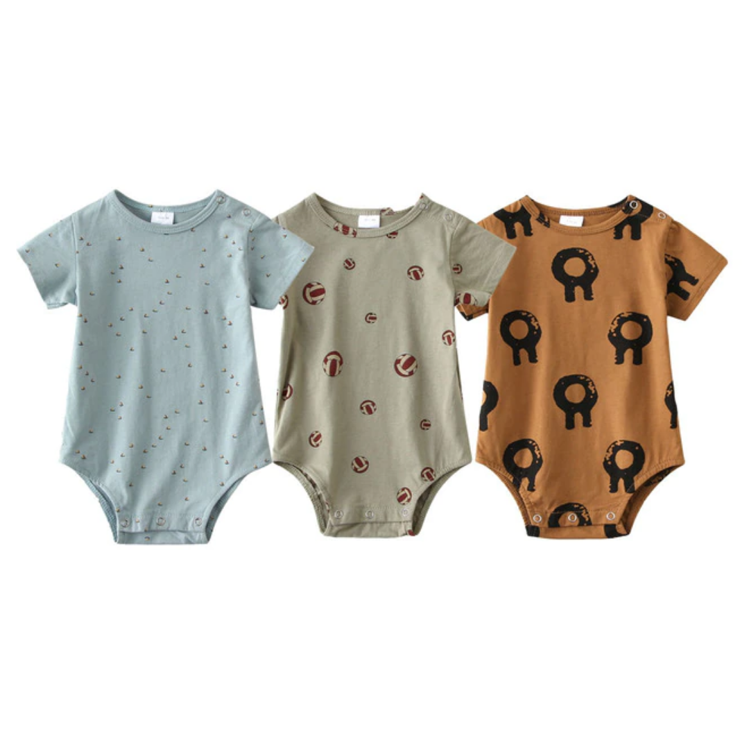 Overhead view of a 3-pack of soft cotton short-sleeve baby rompers with charming patterns