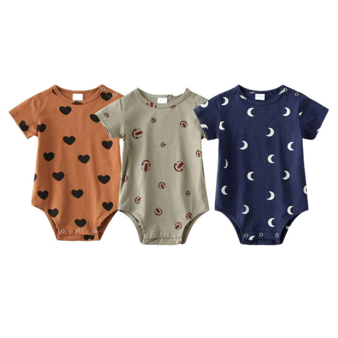 Collection of three unisex baby rompers, soft cotton with diverse patterns, essential short-sleeve infant wear