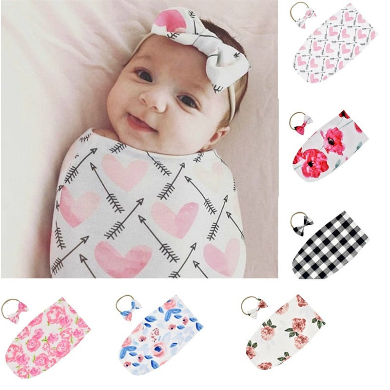 Unisex baby sleeping bag and matching headband set in soft cotton blend, ideal for newborns.