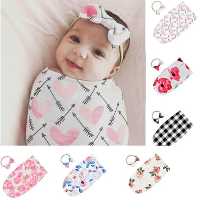 Unisex baby sleeping bag and matching headband set in soft cotton blend, ideal for newborns.