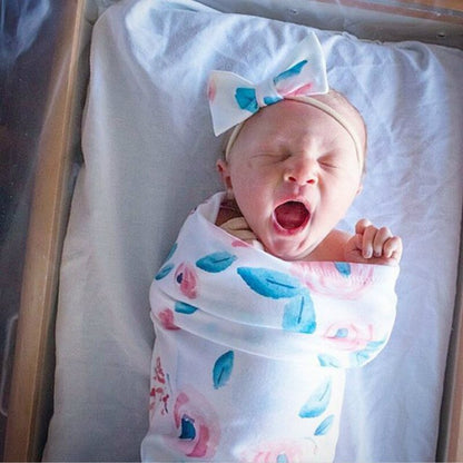 Baby shower gift set: soft baby sleeping bag and comfortable infant headband.