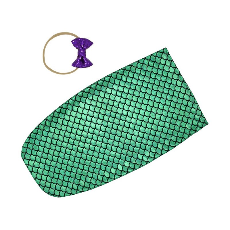 Soft infant swaddle sleep sack with coordinating baby headband, perfect for comfortable sleep.