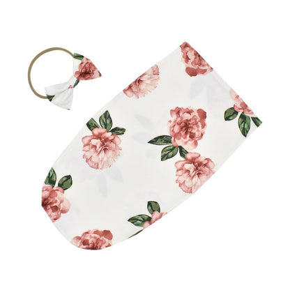 Comfortable baby sleeping bag with attached headband, made from breathable cotton blend fabric.