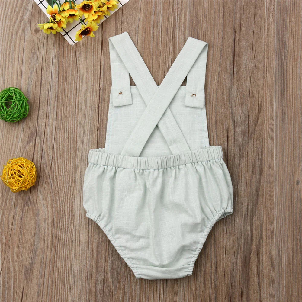 Close-up of soft cotton fabric on a unisex baby sleeveless romper, gentle on skin