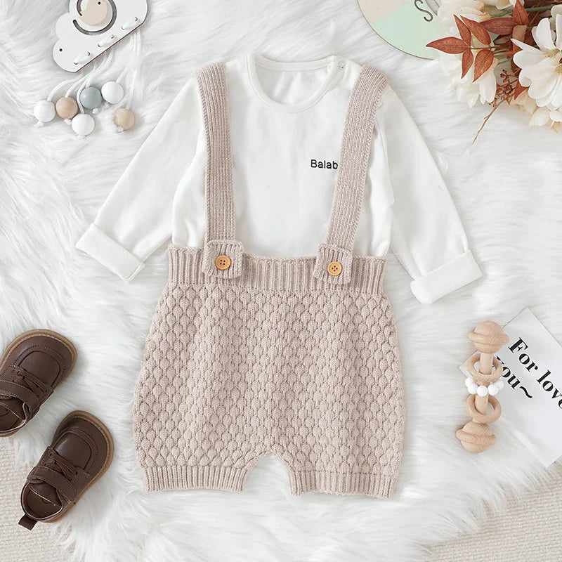 Close-up of a knitted baby romper texture, showcasing the soft acrylic fabric.