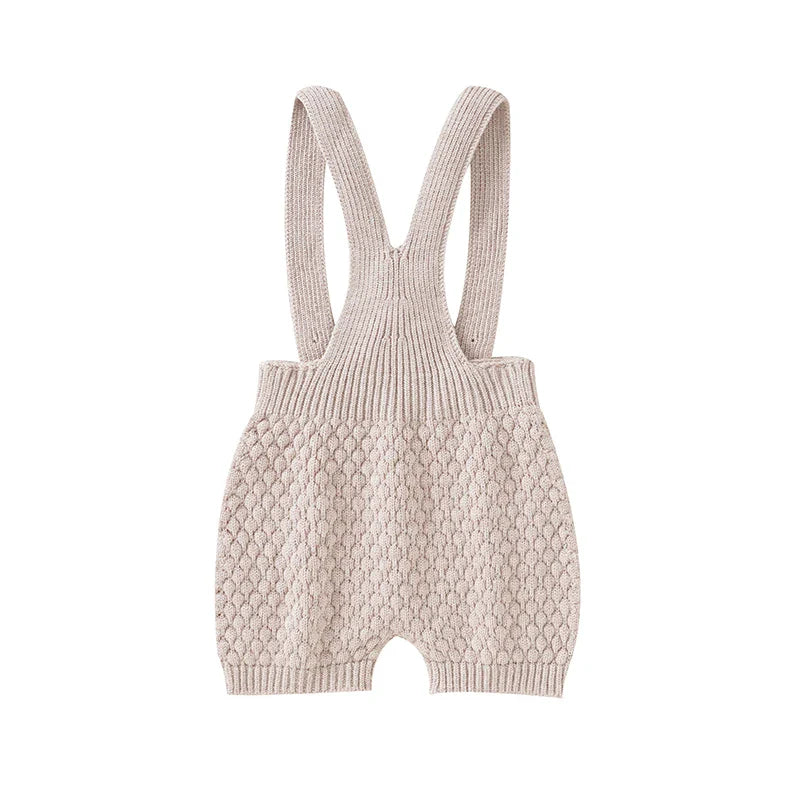 Baby in a sleeveless romper, comfortably playing on a blanket, ideal summer wear.