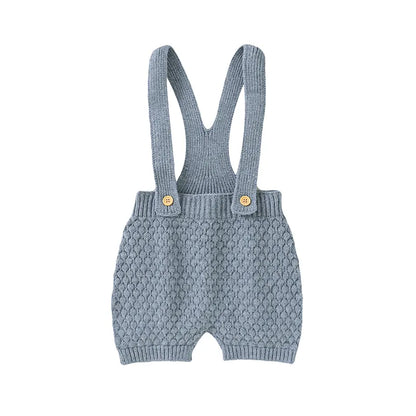 Folded unisex baby romper, highlighting its simple design and knit texture.