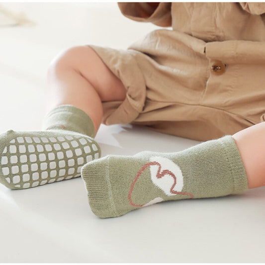 Unisex baby socks with cute cartoon animal design and anti-slip grip for safe play on floors