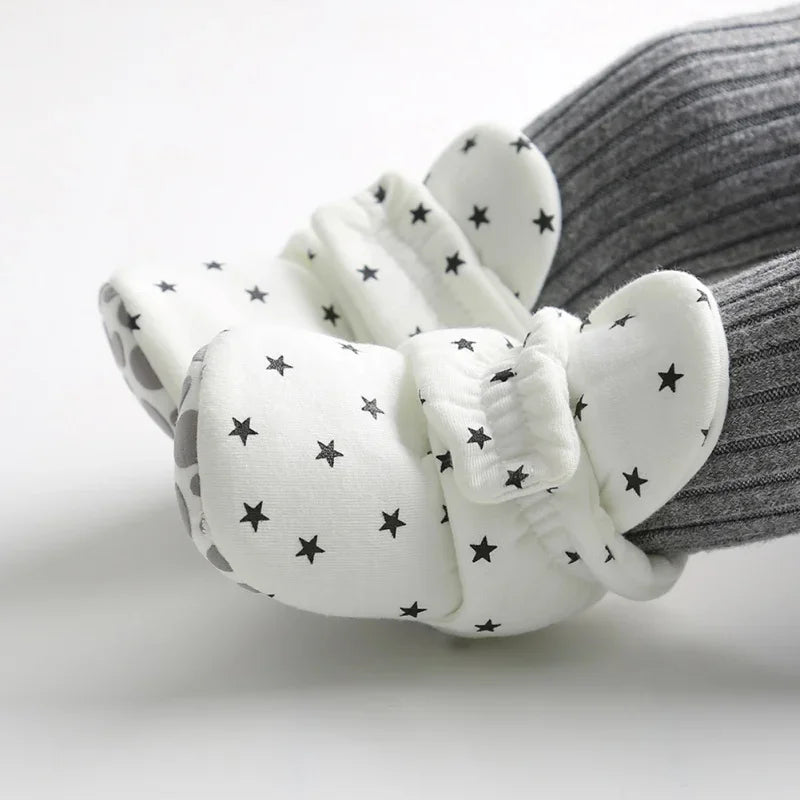 Unisex infant shoes with anti-slip grip, designed for baby's early walking stages.