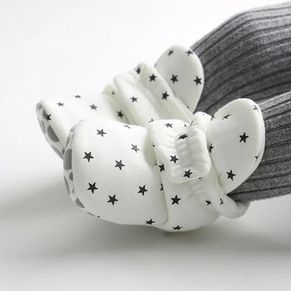 Unisex infant shoes with anti-slip grip, designed for baby's early walking stages.