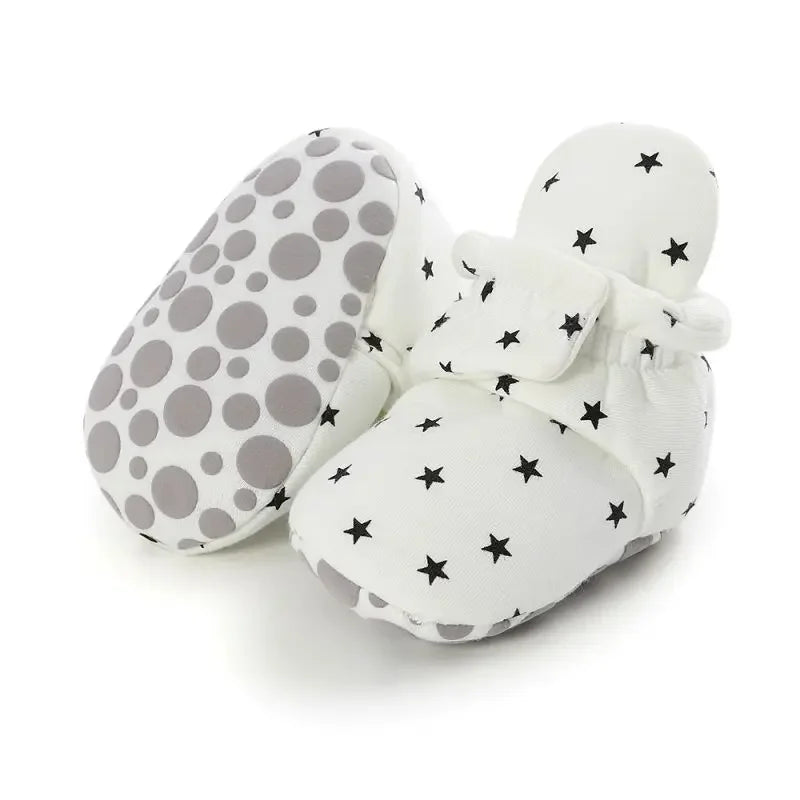 Close-up of soft anti-slip baby crib shoes, showing detailed texture and design.