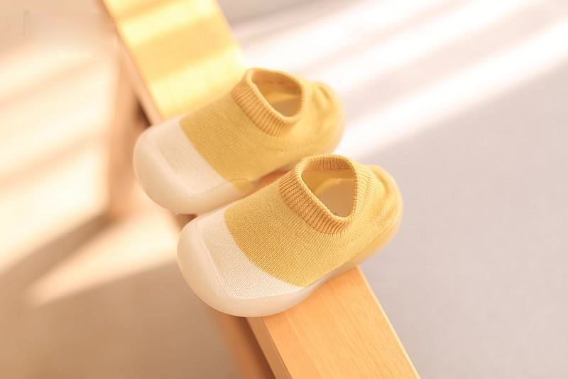 Side view of gray unisex soft sole toddler shoes, ideal for early walking development