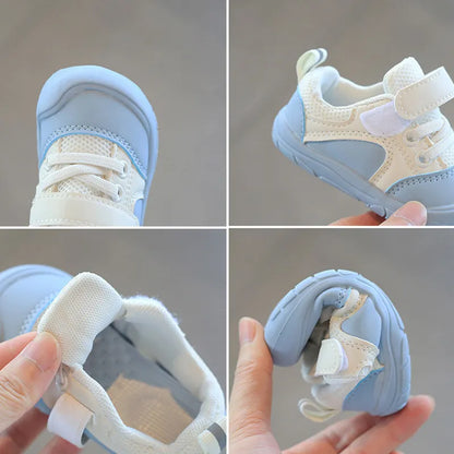 Pair of black soft sole baby sneakers, anti-skid for safe first steps and active toddlers.
