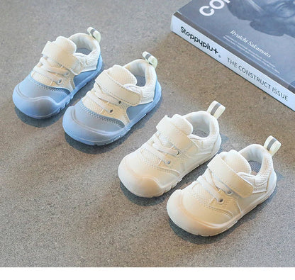 Side view of a unisex baby sneaker, showcasing the soft sole and breathable material.