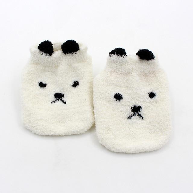 Pair of super soft fuzzy baby socks in gender-neutral yellow, essential for newborn comfort.