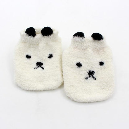 Pair of super soft fuzzy baby socks in gender-neutral yellow, essential for newborn comfort.