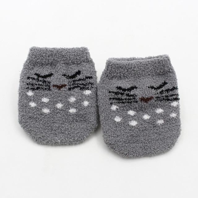 Grey super soft fuzzy baby socks with non-slip bottoms for safe crawling toddlers and infants.