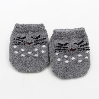 Grey super soft fuzzy baby socks with non-slip bottoms for safe crawling toddlers and infants.