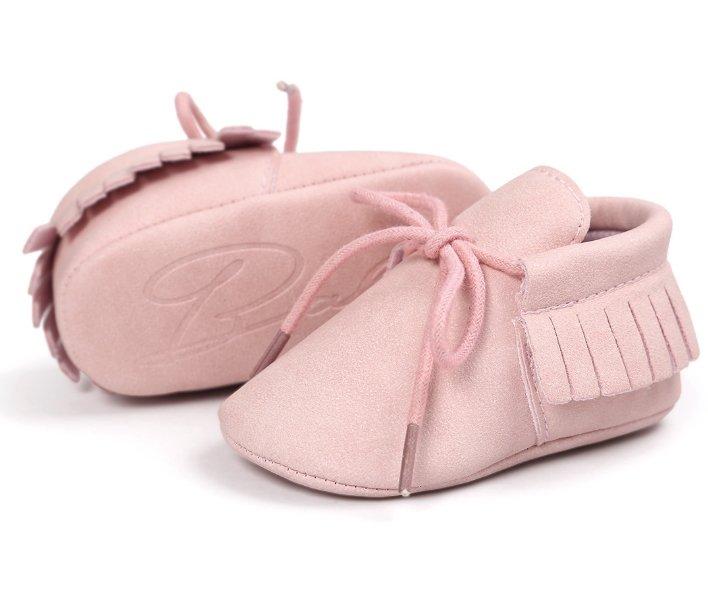 Overhead shot of unisex baby tassel moccasins, showcasing the soft sole and faux suede material.