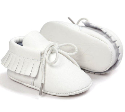 Collection of unisex baby tassel moccasins in various soft colors, anti-slip toddler footwear.
