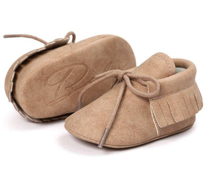 Unisex baby booties with tassels and anti-slip sole, perfect for new walkers and baby fashion.