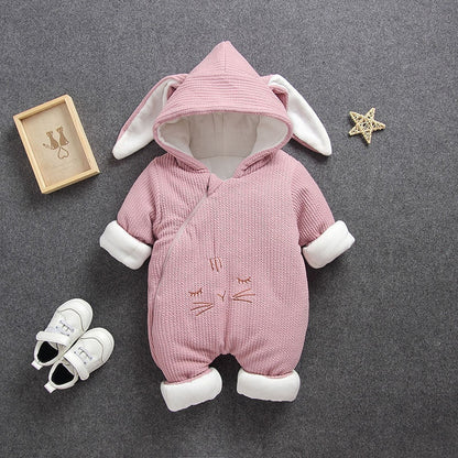 Adorable baby model showcasing a warm hooded animal jumpsuit, a cozy winter romper choice